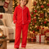 Cheerful Boy in Red Christmas Pyjamas Raff & Roo The Christmas Club Pyjamas